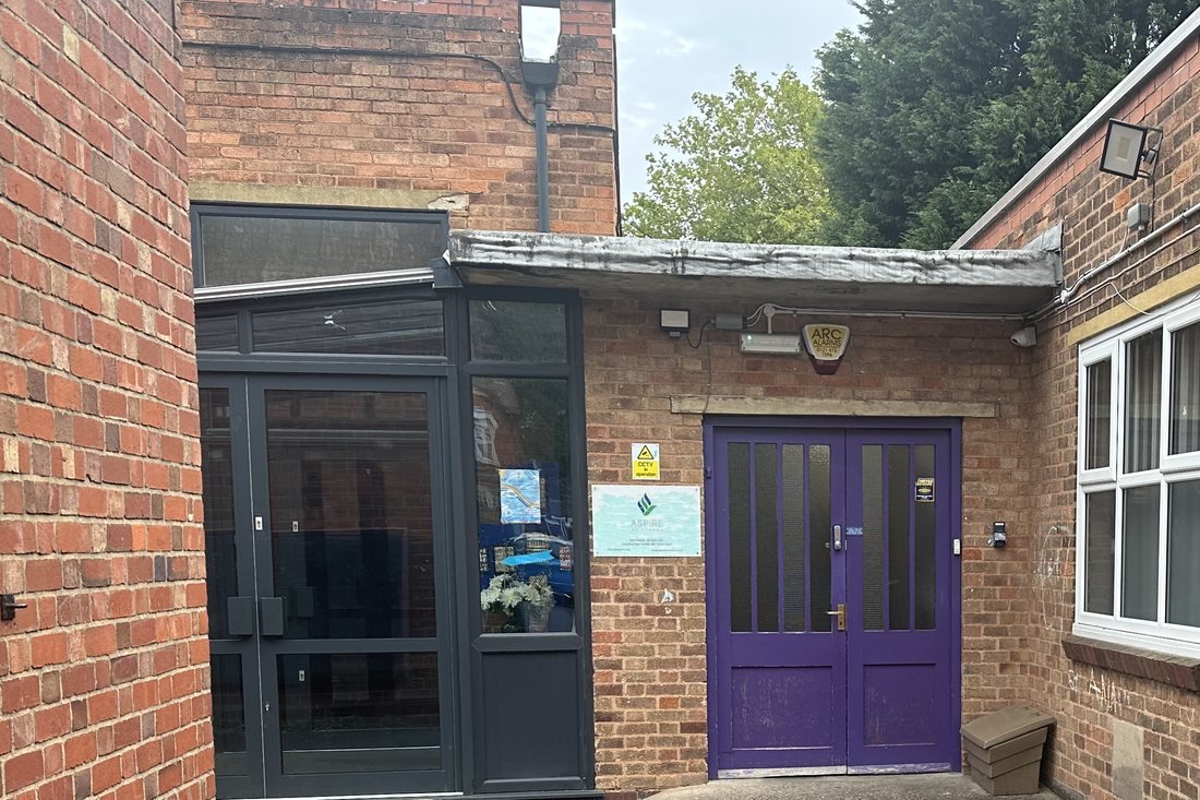 The entrance to Aspire Hall Green, with its glazed porch and purple doors