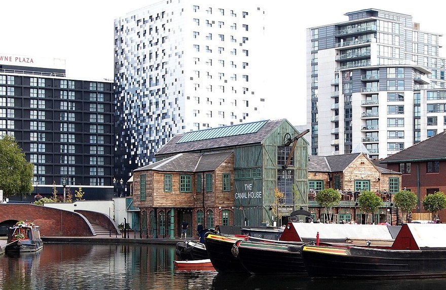 Gas Street Basin in Birmingham: narrowboats moored beside the old canalside warehouses, with the city’s modern towers behind